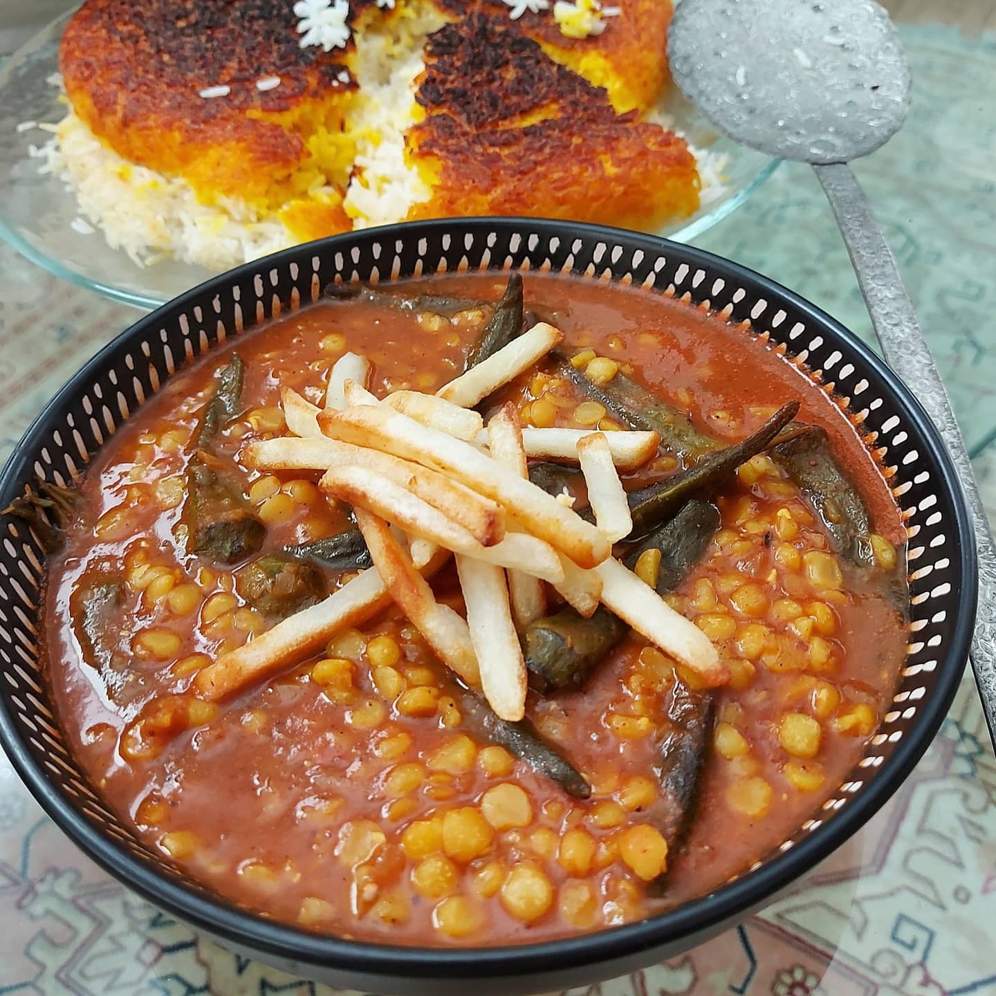 Persian Gheymeh vegetarian. Aromatic stew with yellow split peas and french fries on top