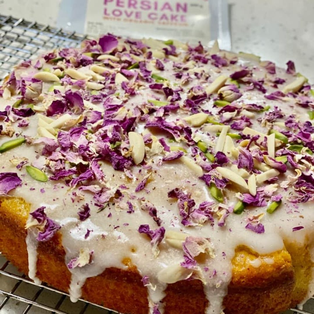 Persian Saffron Love Cake with rosewater icing and rose petal and almond and pistachio garnish. A gluten free friendly cake. Made with pre mix